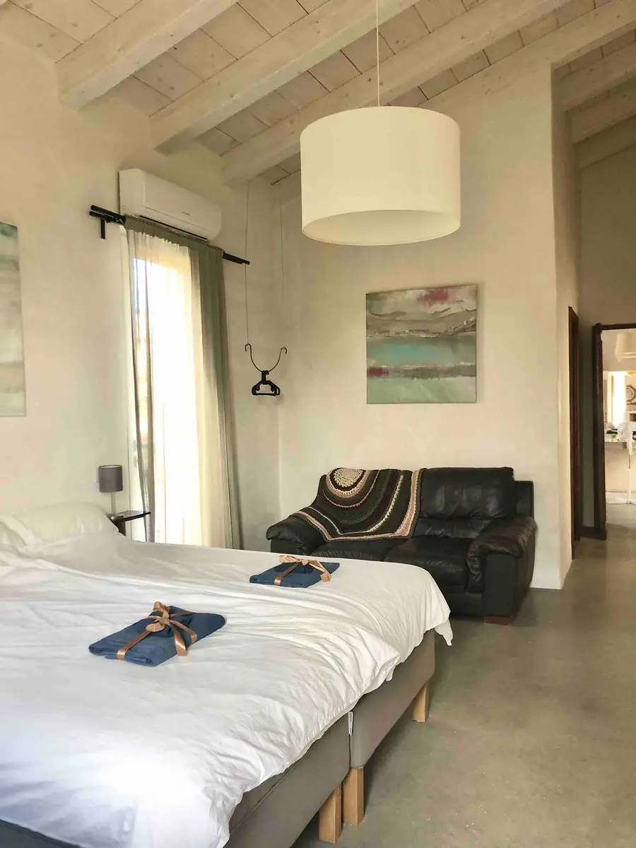 Room 2 made up for arrival, with towels folded on the bed